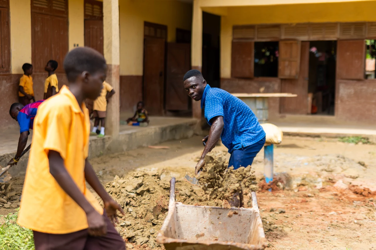 Construction beside the school building, documented during the project.